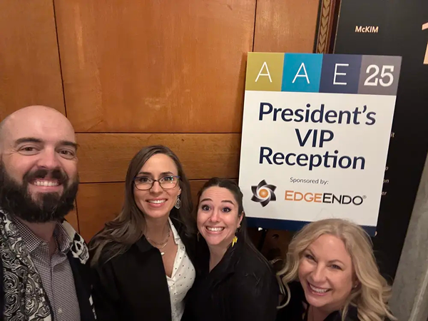 Four EdgeEndo team members posing by a sign that says President's VIP Reception